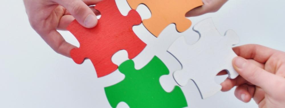 Group of business people assembling jigsaw puzzle.jpg